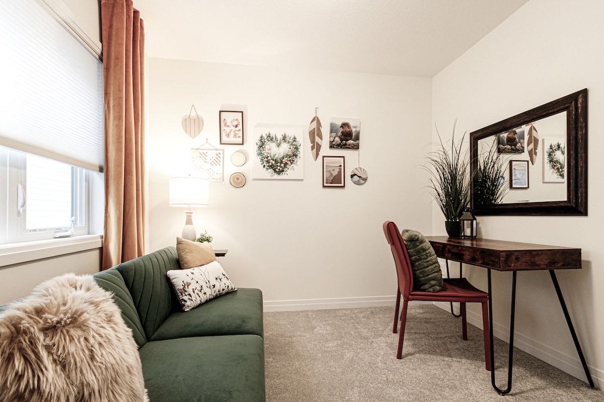The Earth Room: a green sofa bed and a small writing desk